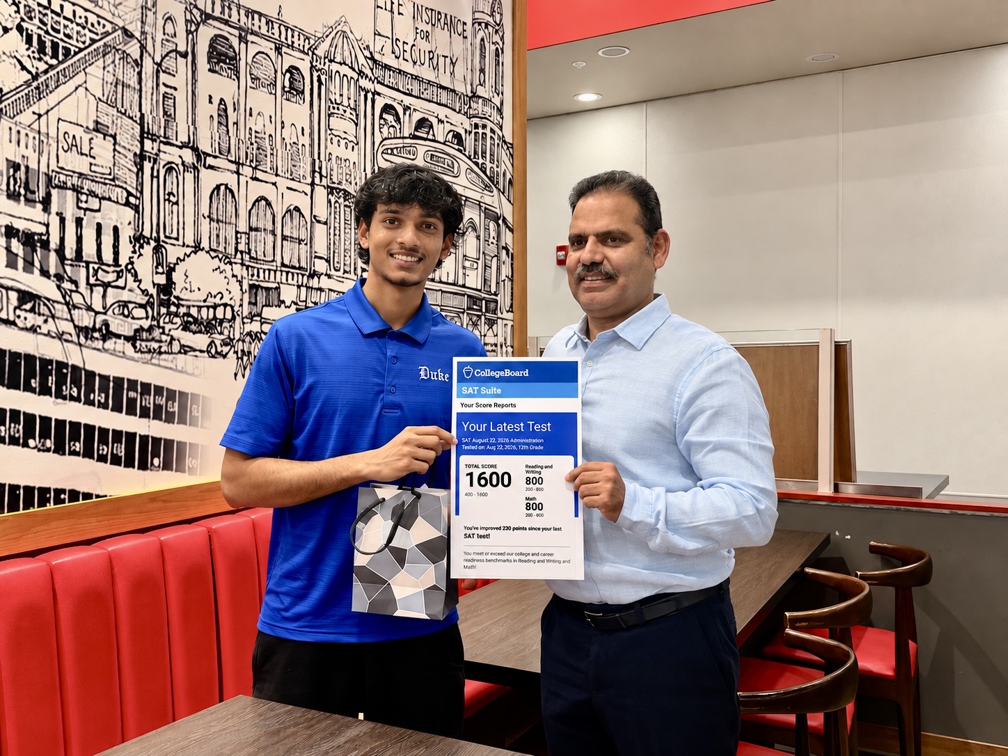 Vikas Kapoor with his student Sid holding his 1600 SAT score report